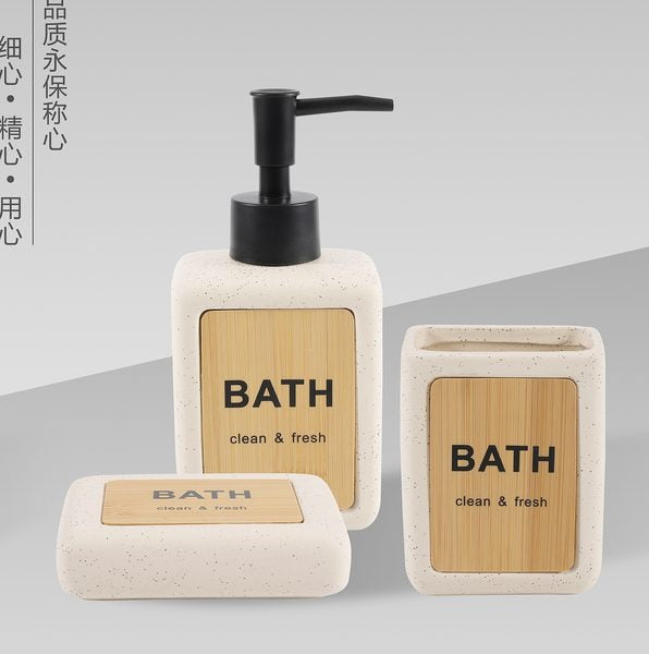 Beige ceramic 3-piece bathroom set with bamboo wood accents: lotion dispenser, tumbler, and soap dish