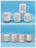 White ceramic mugs with black coffee-themed lettering, leafy details and contrasting coloured bases