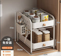 Cream white two-tier drawer organizer with pull-out drawers and a side cutlery basket, holding jars and utensils