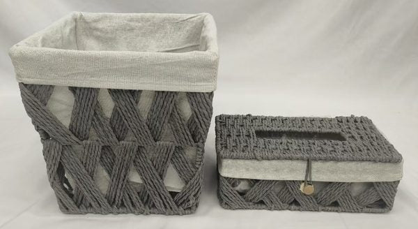 Gray woven paper basket with light fabric liner beside a matching gray woven tissue box holder
